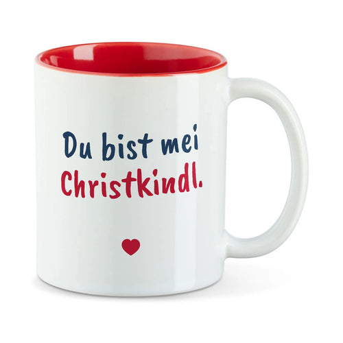 Weiße Tasse mit roter Innenseite und dem bairischen Spruch „Du bist mei Christkindl.“ in Pinselschrift.