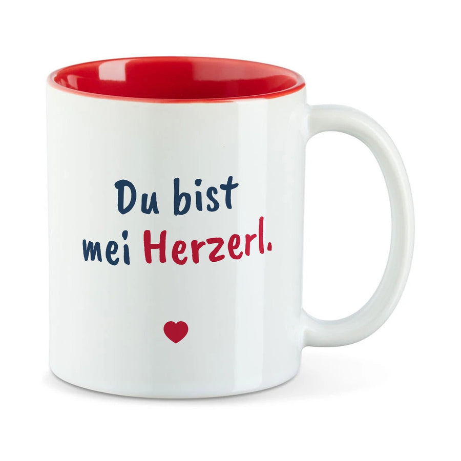 Weiße Tasse mit roter Innenseite und dem bairischen Spruch „Du bist mei Herzerl.“ in Pinselschrift.