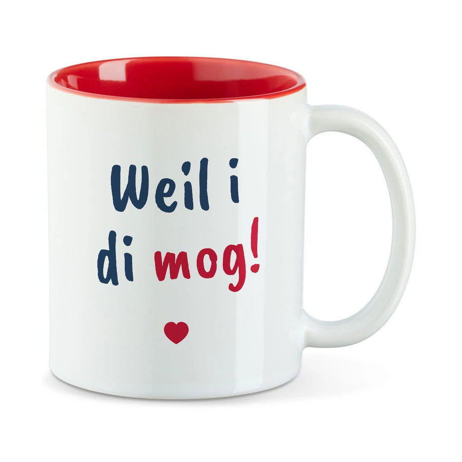 Weiße Tasse mit roter Innenseite und dem bairischen Spruch „Weil i di mog!“ in Pinselschrift.