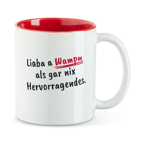 Weiße Tasse mit roter Innenseite und dem bairischen Spruch „Liaba a Wampm als gar nix Hervorragendes.“ in Pinselschrift.